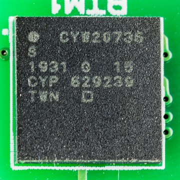 A Cypress CYW20735 BLE system-on-chip in a fine-pitch BGA package on a green PCB
