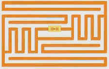 An RFID inlay showing a spiral antenna trace with a tiny chip at its center