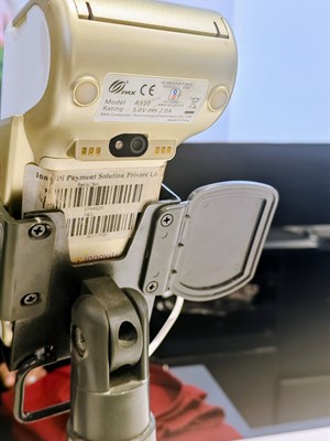 An NFC-capable point-of-sale payment terminal on a stand