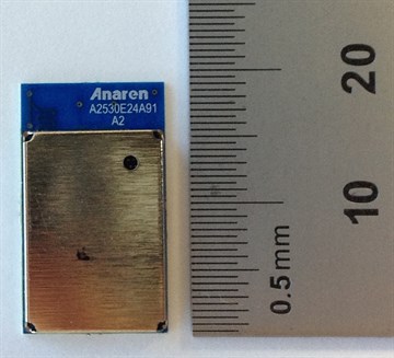 An Anaren 802.15.4 RF module with a metal shield and a printed antenna in one corner