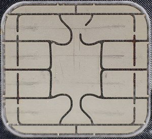 The gold EMV contact pad on a payment card, the visible face of its secure element