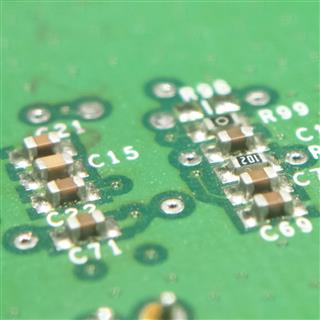 Surface-mount decoupling capacitors beside a processor on a board