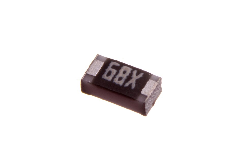 Macro photograph of a single 0603 chip resistor marked 68X