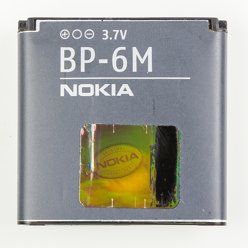 Nokia BP-6M lithium polymer battery pack, label showing 3.7V, polarity symbols and a hologram window