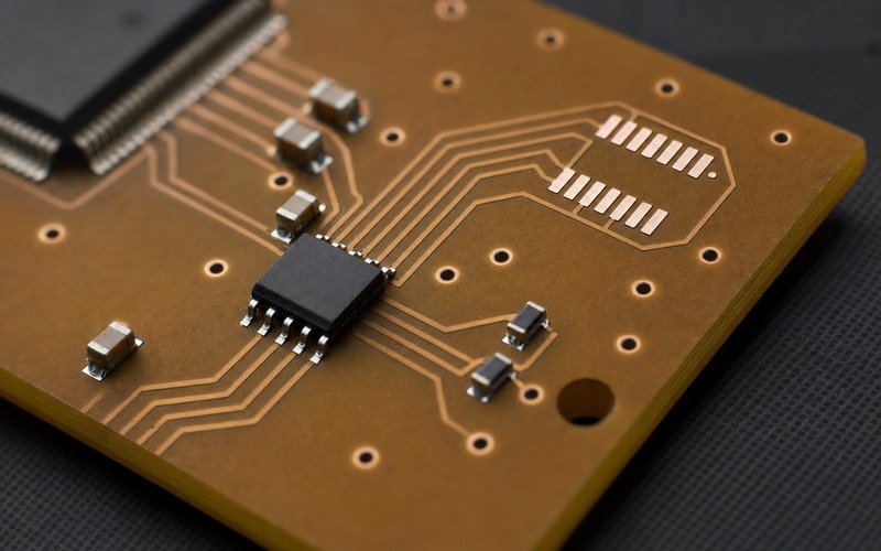 Serial NOR flash detail with four QSPI traces, blank alternate footprint, decoupling capacitors and copper vias for package review