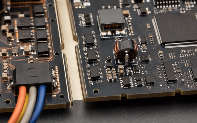 Close detail of isolation slots, digital isolators, filter components and quiet-side control circuitry on a robotics PCB