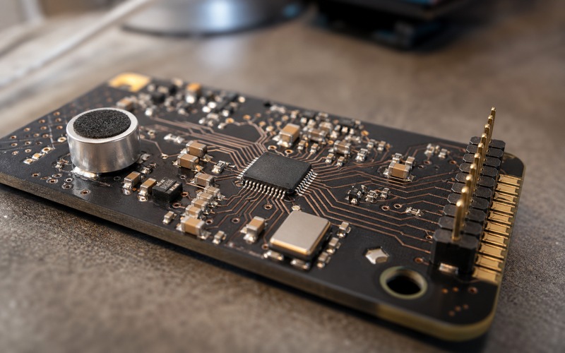 PDM microphone and I2S audio interface circuit on a compact PCB showing microphone placement, bridge IC, clock parts and edge-facing digital audio connector