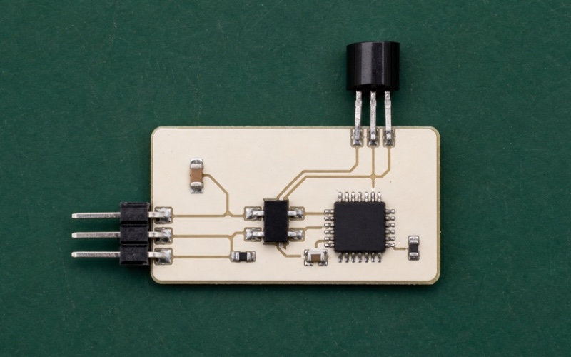 Top-down ivory sensor interface with a TO-92 thermometer at the board edge, three-pin bus connector, ESD protection and one pull-up resistor