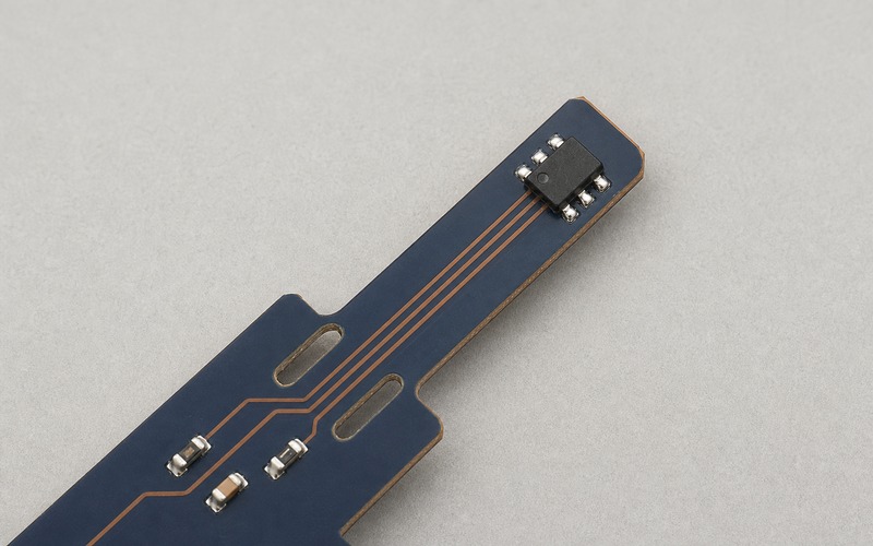 Top-down navy PCB thermal finger with a six-pad WSON sensor, isolation slots and four copper traces